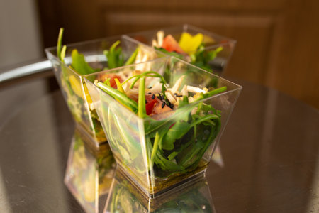 tomato salad in a plastic cup at the buffet.の写真素材