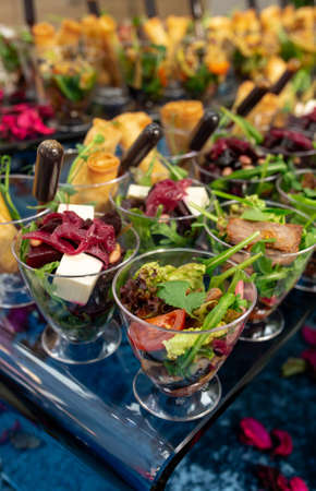 salads and snacks in plastic cups on the buffet.の写真素材