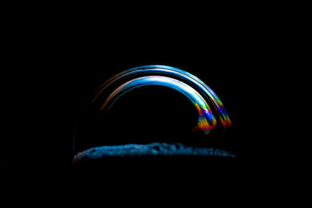 soap bubble close-up on a black background. macro photo isolated bubble.の写真素材