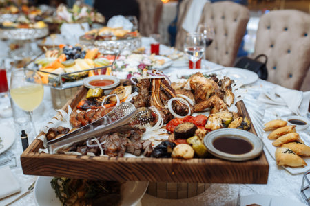 grilled meat set on a wooden board on the tableの写真素材