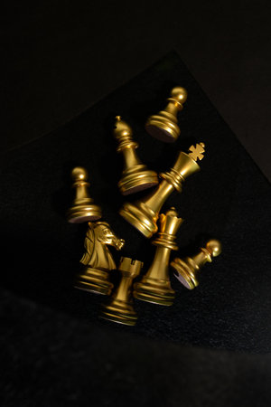 Golden chess pieces on a black background close-up.の写真素材