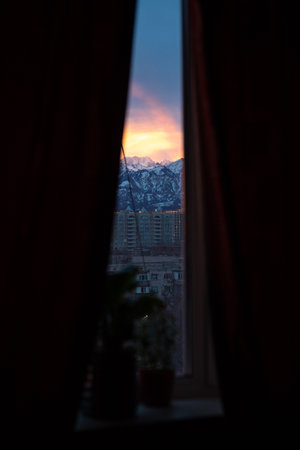 dawn on the background of mountains. view from the window.の写真素材
