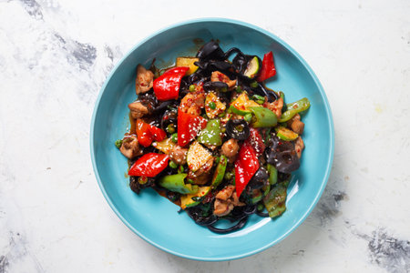 top view of black lagman with chicken and pepper in a blue plate.の写真素材