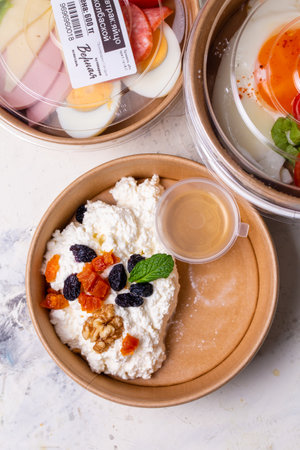 Breakfast cottage cheese with dried fruits top view. tomorrow in craft dishes.の写真素材