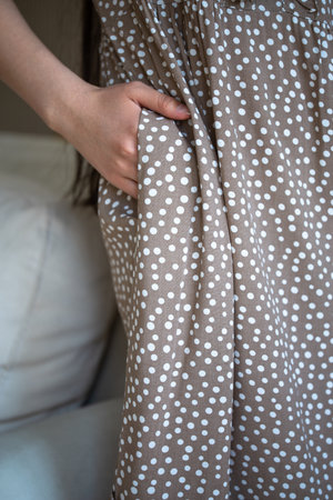 close-up of a girls hand in a dress pocketの写真素材