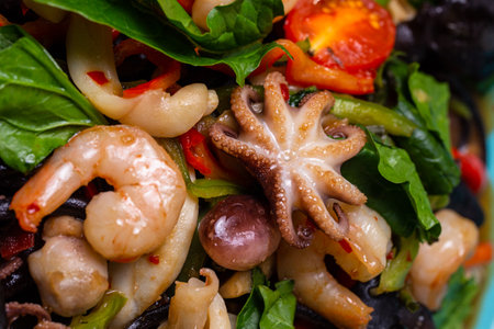 top view seafood salad in a blue plate in a restaurant. Shrimp, octopus squid close-upの写真素材