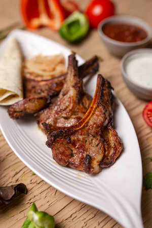 delicious Juicy shish kebab of lamb ribs cooked on fire, shish kebab on a white plate in a cafe....