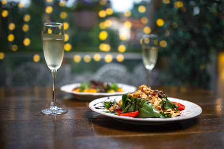 glasses of champagne and salads on bokeh backgroundの写真素材