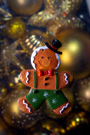christmas toy gingerbread on the background of golden toys.