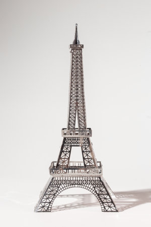 Metal Eiffel Tower cutout on white background. Lattice design highlights skill and precision, creating intricate pattern.の写真素材