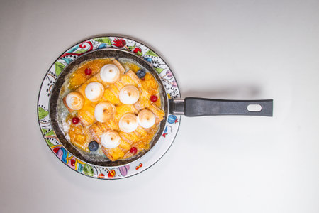 A delicious and easy-to-make breakfast of pancakes with blueberries and lingonberries. The perfect way to start your dayの写真素材