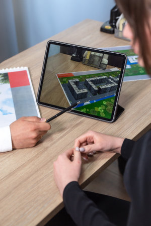 A business woman is sitting at her desk and using a tabletの写真素材