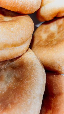 Closeup of a stack of freshly baked homemade bread buns with a golden crust, perfect for breakfast,...