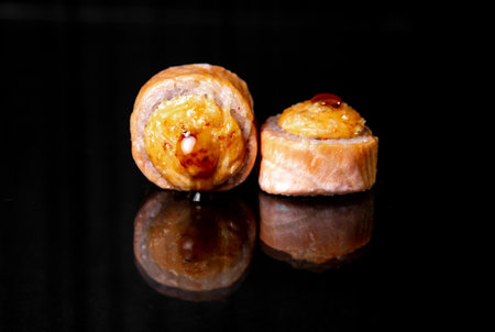 rolls with reflection on black background, photo for menu designの写真素材