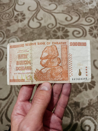 A close-up of a Fifty Billion Dollars Zimbabwean banknote. The banknote features the image of the balancing rocks of Matopos on the front.の写真素材