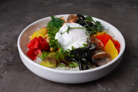 A delicious and healthy poke bowl filled with fresh salmon, a soft-boiled egg, and an assortment of...
