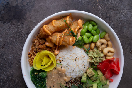 A delicious and healthy poke bowl filled with fresh ingredients like avocado, cucumber, edamame,...