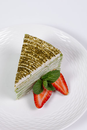 low-fat spinach cake with cheese cream on a white plate.の写真素材