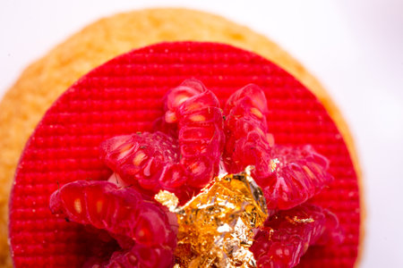 Top-down view: dessert with raspberry and gold - luxury, symmetry and bold colors