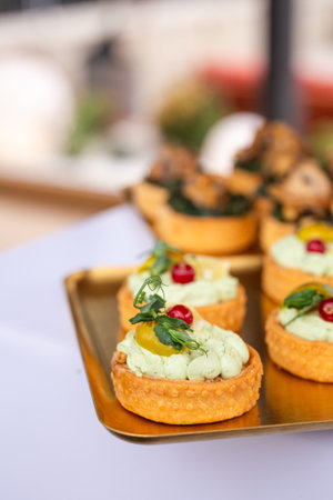Elegant bite-sized pastries with earthy mushrooms and fresh herbs - ideal for upscale catering, wedding receptions or gourmet food visuals.の写真素材