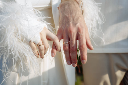 Intimate moment of joined hands - one gently bandaged, symbolizing care, commitment and real-life...