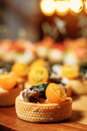 Close-up of mini tart with mushrooms and cherry tomato - appetizing appetizerの写真素材