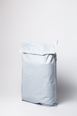 Close-up of white postal mailer with self-adhesive seal on white background.の写真素材