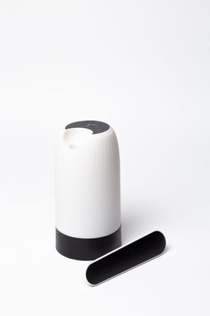 Sleek white touchless soap dispenser with black lever pump and curved spout - modern hygienic...