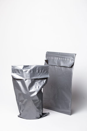 Silver Metallic Mailer Bags Crumpled and Flat Pair on white background