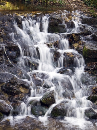 Small waterfall under the Bridge of Sighs, in the gardens of the Royal Palace of La Granja, Segovia, Spainの写真素材