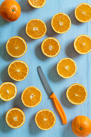 Several oranges and knife on an old blue wooden backgroundの写真素材