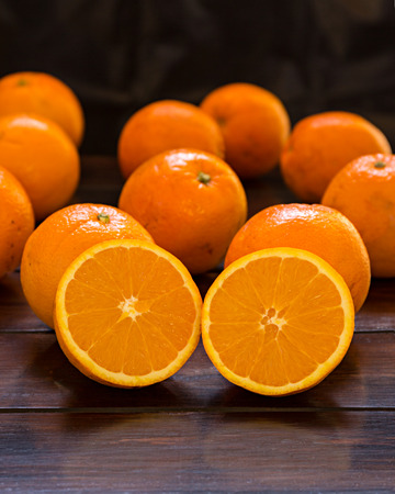 Several oranges on an old wooden tableの写真素材