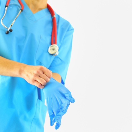 Doctor putting on medical gloves の写真素材