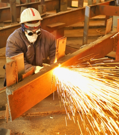worker using torch cutter to cut through metalの写真素材
