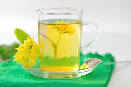 cup of linden tea and flowers の写真素材