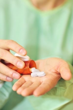 doctor holding bottle of prescription pills の写真素材