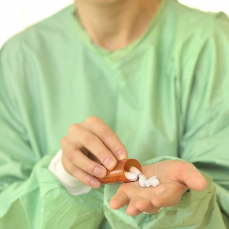 doctor holding bottle and  pillsの写真素材