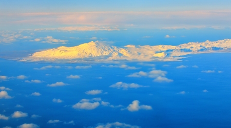 aerial view of mountains and clouds on top at sunriseの写真素材