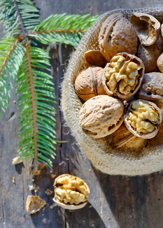 walnuts isolated  in burlap bag on wooden の写真素材