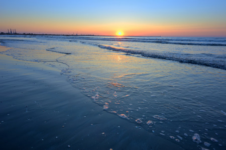 landscape with sunshine over sea shoreの写真素材