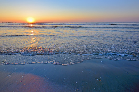 waves and sunrise on Black Sea beachの写真素材