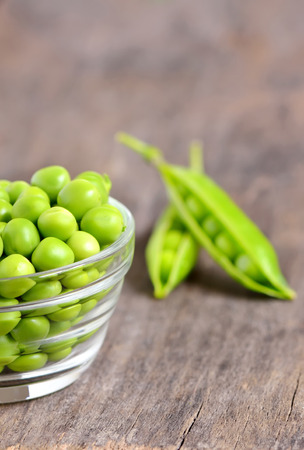 Fresh peas isolated on old wooden の写真素材
