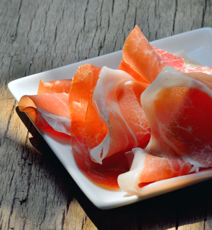 slices of Prosciutto di Parma on plateの写真素材