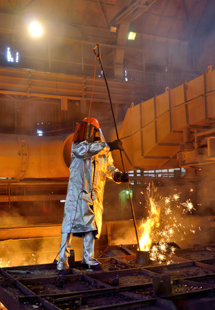 Working in a foundry at a steel plantの写真素材