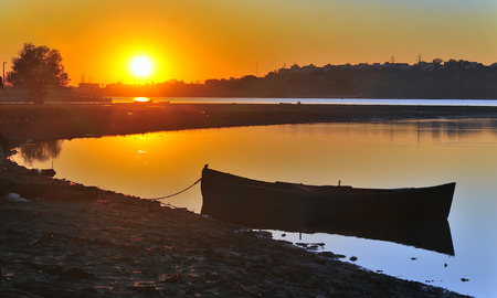 silhouette of fishing boat with sunriseの写真素材