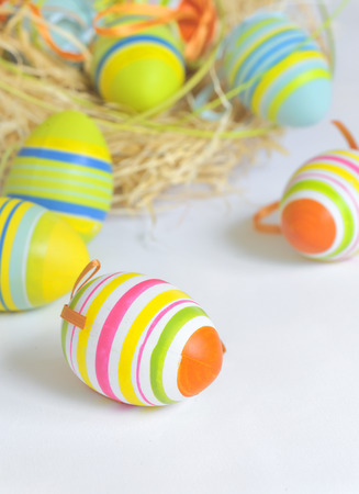 Easter eggs in nest and white backgroundの写真素材