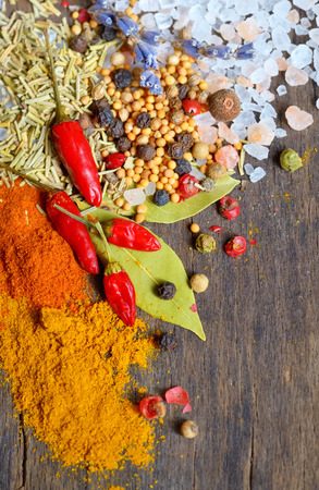 Herbs and spices on old table woodの写真素材