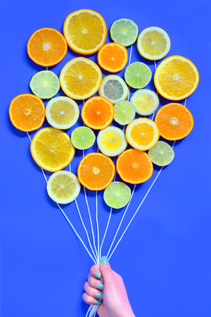 Citrus  slices fruits concept on blue backgroundの写真素材
