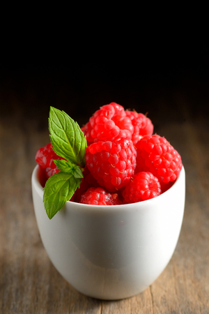 Raspberry fruit isolated on wooden tableの写真素材