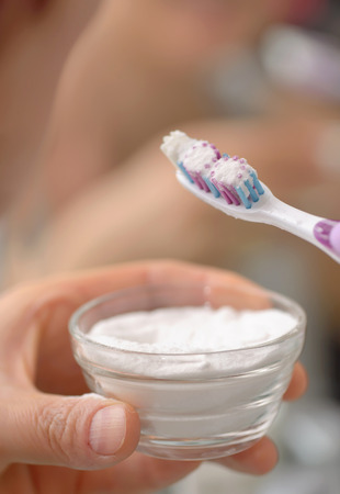 Woman brightening teeth with sodium bicarbonateの写真素材